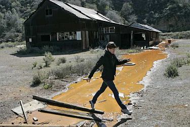 Abandoned mercury mine sending polluted, orange waste into creek.